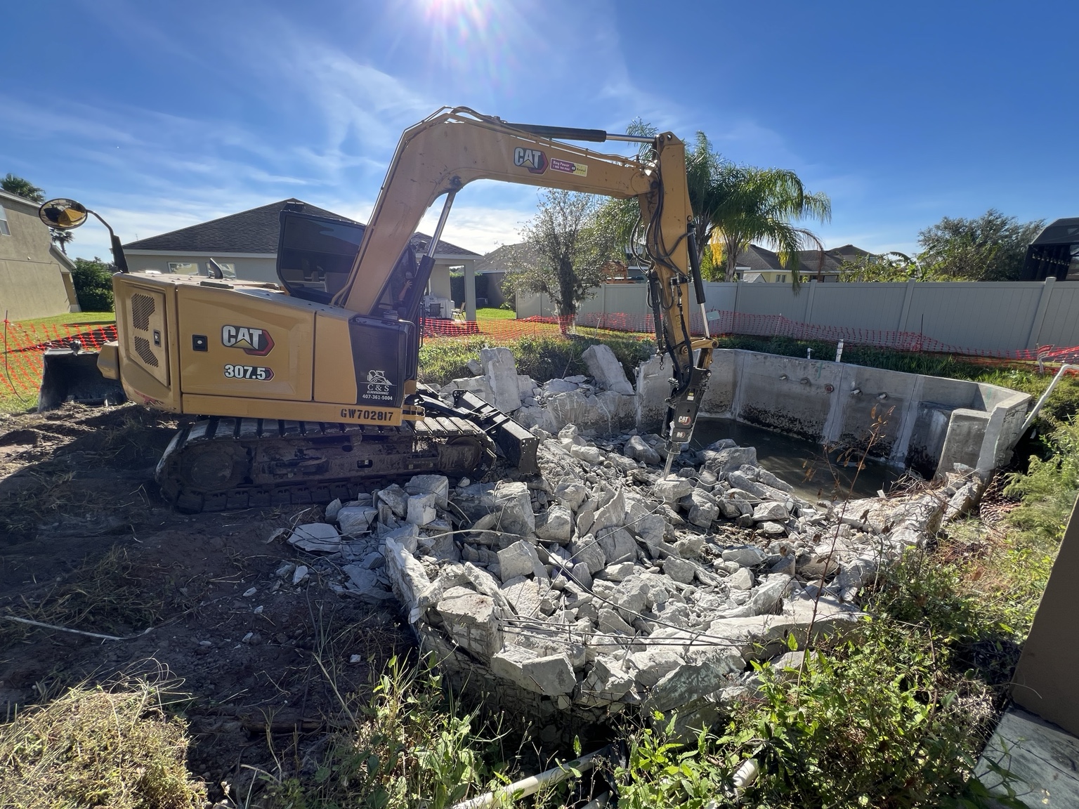 Pool and concrete demolition with CAT excavator
